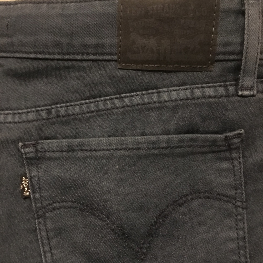 Distressed dark wash Levi skinny jeans